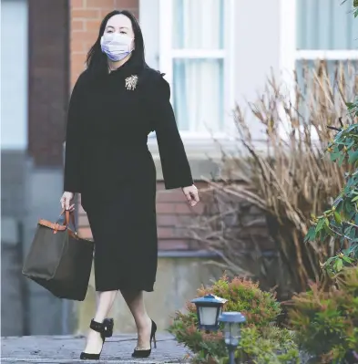  ?? JONATHAN HAYWARD / THE CANADIAN PRESS ?? Huawei chief financial officer Meng Wanzhou leaves her home in Vancouver on Wednesday. Meng, who is free on bail
while fighting extraditio­n to the U.S., is seeking to have the terms of her release conditions eased.