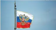  ?? (Bloomberg/ Andrey Rudakov). ?? The Russian coat of arms sits on a Russian flag flying on the roof of the Kremlin in Moscow