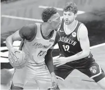  ?? FRANK FRANKLIN II/AP ?? Nets’ Joe Harris (12) defends against the Heat’s Bam Adebayo during Saturday night’s game in New York.