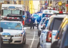  ?? AP PHOTO ?? Police block a street by Port Authority Bus Terminal near New York’s Times Square following an explosion. Police say the explosion happened in an undergroun­d passageway under 42nd Street between Seventh and Eighth avenues.