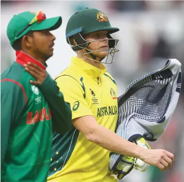  ?? Photo: Zimbio ?? Steven Smith of Australia leaves the field with his bat wrapped in a towel to protect it from the falling rain as play got suspended during the ICC Champions Trophy cricket against Bangladesh at The Oval in London on June 5, 2017.