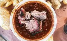  ??  ?? Texans love dunking smoked brisket in their bowl of red chili.
