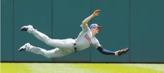  ?? Duane Burleson / Getty Images ?? Bradley Zimmer takes a hit away from Detroit’s Mikie Mahtook with a diving catch in center July 1. For an encore, Zimmer robbed Mahtook of another hit in the second game that day.