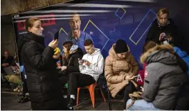  ?? EMILIO MORENATTI / ASSOCIATED PRESS ?? People sit in a subway station being used as a bomb shelter during air siren warnings in Kyiv, Ukraine, on Tuesday.