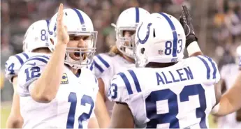  ?? | AP ?? The Colts’ Andrew Luck ( left) and Dwayne Allen hooked up for three touchdown passes in the first half.