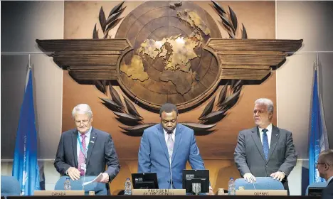  ?? PAUL CHIASSON/THE CANADIAN PRESS ?? From left, federal Transport Minister Marc Garneau, ICAO president Olumuyiwa Benard Aliu and Quebec Premier Philippe Couillard at the opening session Tuesday of the UN aviation agency in Montreal. Delegates from 191 countries are expected to approve a...