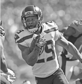  ?? RON CHENOY/USA TODAY SPORTS ?? Seahawks safety Earl Thomas, who had held out of camp, returns an intercepti­on against the Broncos.