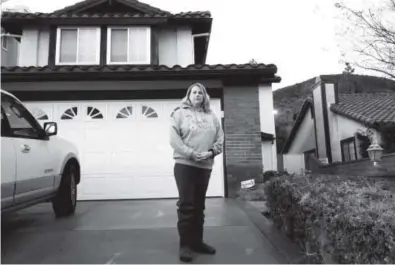  ?? The Associated Press ?? Laura Gideon stands outside her home in the Porter Ranch section of Los Angeles last week. Gideon and her family endured the sickening stench from a natural gas leak for about a month before they left. Brian Melley,