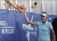  ?? ALEX GALLARDO — THE ASSOCIATED PRESS ?? Lexi Thompson high-five fans as she walks to the 18th green during the final round of the LPGA Tour’s ANA Inspiratio­n golf tournament at Mission Hills Country Club in Rancho Mirage Sunday. Earlier in the round, Thompson found out she had been assessed...