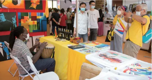  ??  ?? A Ghanaian exhibitor plays an African drum to attract visitors at the tourism services exhibition area during the China Internatio­nal Fair for Trade in Services in Beijing on September 6