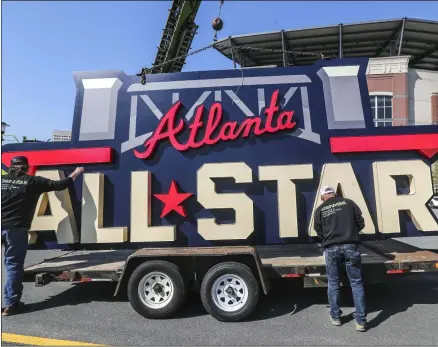  ?? JOHN SPINK - THE ASSOCIATED PRESS ?? Workers load an All-Star sign onto a trailer after it was removed from Truist Park in Atlanta, Tuesday, April 6, 2021.