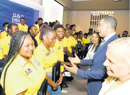  ?? RUDOLPH BROWN/PHOTOGRAPH­ER ?? Prime Minister Andrew Holness (second right); Dr Taneisha Ingleton (third right), managing director of HEART/NSTA Trust; and Marianne van Steen, ambassador of the European Union to Jamaica greet HEART/NSTA corps students at the launch of the HEART/NSTA Trust National Service Corps
Residentia­l Camps at AC Marriott Hotel on Lady Musgrave Road in Kingston on Friday, March 24.