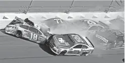  ?? JOHN CHILTON/AP ?? Dale Earnhardt Jr. (88) hits Kyle Busch (18) along with Erik Jones (77), Matt Kenseth (20) and Elliott Sadler (7) during the Daytona 500 on Sunday at Daytona Internatio­nal Speedway.