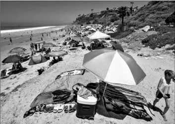  ?? Mark Rightmire/The Orange County Register via AP ?? Umbrellas, blankets and towels are socially distanced in San Clemente, Calif. on Saturday.