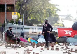  ??  ?? Protesters keep watch at a barricade outside the Hong Kong Polytechni­c University in Hong Kong, China, November 15, 2019. (Reuters)