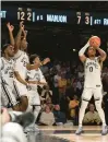  ?? GEORGE WALKER/AP ?? Vanderbilt guard Tyrin Lawrence shoots the winning 3-pointer at the buzzer to give the Commodores an upset of Tennessee on Wednesday in Nashville.