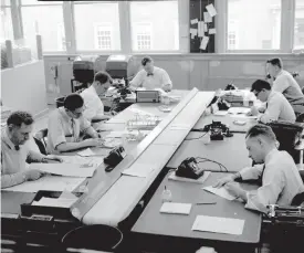  ?? THE RECORD ?? The Record's newsroom copy desk in 1954.