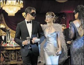  ?? DOANE GREGORY/UNIVERSAL PICTURES VIA AP ?? Jamie Dornan stars as Christian Grey, left, and Dakota Johnson as Anastasia Steele in “Fifty Shades Darker.”