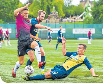  ??  ?? East Kilbride’s Bernard Coll gets a strong challenge in on St Mirren’s Kyle Magennis