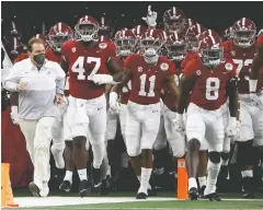  ?? The Associated Press ?? Alabama head coach Nick Saban, front left, jogs onto the field with his team for the Rose Bowl against Notre Dame in Arlington, Texas, on Jan. 1.