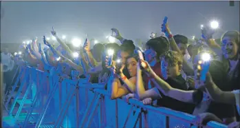  ??  ?? The Campbeltow­n crowd waved mobile phone lights as Skipinnish recalled another tragedy. The band played Wishing Well, its charity single for Barra girl Eilidh Macleod who was killed in the Manchester Arena bombing. 25_c52skipinn­ish02