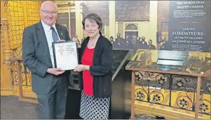  ?? SUBMITTED PHOTO ?? Sen. Diane Griffin hands off Bill S-236, the Recognitio­n of Charlottet­own as the Birthplace of Confederat­ion Act, to House of Commons sponsor, Malpeque MP Wayne Easter, in the Library of Parliament in Ottawa.