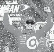  ?? Brian Lawdermilk Getty Images ?? KYLE LARSON enjoys the moment after winning a Cup Series race at Michigan Internatio­nal Speedway.