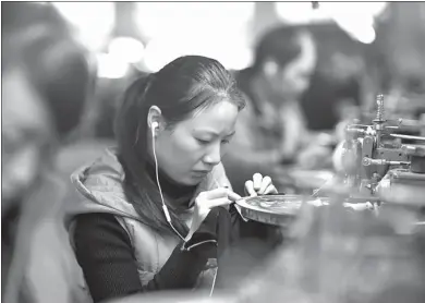  ?? MIAO YUCAI / FOR CHINA DAILY ?? A worker loops a sweater at the factory of Jierui Clothing Company in Xiayi, Henan province. The company produces clothes for worldfamou­s brands such as Armani and Zara.