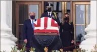  ?? Alex Wong / Getty Images ?? President Donald Trump and first lady Melania Trump pay their respects to Associate Justice Ruth Bader Ginsburg's flag-draped casket at the Supreme Court on Thursday.