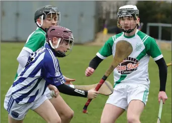  ??  ?? Seán Nunan (Good Counsel College) bursting past St. Peter’s pair Seán Cooney and Fionn Ryan.