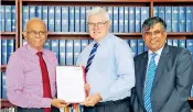  ??  ?? Associate Professor, Gary Noble of the Faculty of Business, University of Wollongong, hands over the formal Letter of Recognitio­n to the President of BMS, Dr W A Wijewarden­a in the presence of SBS’s Dean Nelson Perera, who also holds the post of Head,...