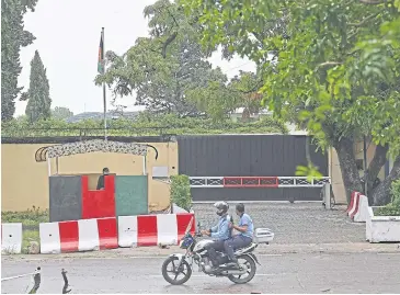  ?? AFP ?? Policemen ride past the Afghan Embassy in Islamabad, Pakistan, yesterday.