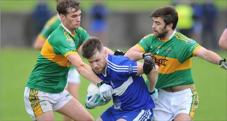  ??  ?? Barry Watters, Dundalk Gaels, is challenged by Michael Clarke and Keith McLaughlin, Sean O’Mahony’s.