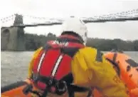  ??  ?? ● RNLI Beaumaris, and other rescue teams, were tasked with rescuing three people and a dog after their boat capsized in the Menai Strait. Pic: RNLI Beaumaris