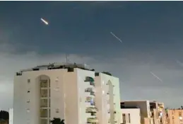  ?? TOMER NEUBERG/AP ?? Israeli “iron dome” air defense system launches to intercept missiles fired from Iran, in central Israel, on Sunday. Iran launched its first direct military attack against Israel on Saturday.