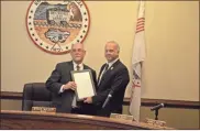  ?? sean Williams ?? Mayor Steve Miller gives Council Member James Payne a copy of a proclamati­on honoring his service to the city as an elected official.