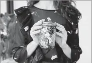  ?? BRIDGET BADORE ?? Lauren Singer of New York claims she’s now able to fit six years of trash into a single Mason jar.