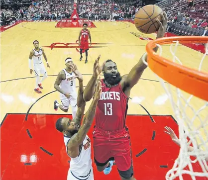  ?? David J. Phillip, The Associated Press ?? The Rockets’ James Harden goes up for a shot as Denver’s Will Barton defends Wednesday night at the Toyota Center in Houston. The Rockets beat the Nuggets 121-105, ending a four-game losing streak.