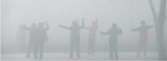  ??  ?? PEOPLE EXERCISE in the smog on a polluted day in Henan province, China earlier this month.