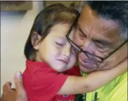  ?? RICK BOWMER — THE ASSOCIATED PRESS ?? Romulo Gonzalez Rodriguez and his 3-year-old daughter Genesis hug during a interview Tuesday in Provo, Utah. Gonzalez Rodriguez spoke about the anguish of being separated from his 3-year-old daughter, Genesis Gonzalez Lopez, for seven days in November after arriving to the U.S. port of entry in San Diego. Gonzalez Rodriguez said he fled his hometown of Champerico, Guatemala to seek asylum in the United States after he was kidnapped and extorted by captors who cut his eye out and nearly killed him.