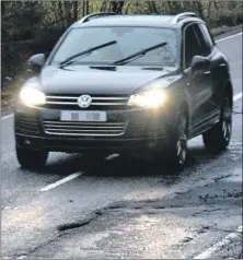  ??  ?? A driver avoiding a pothole on the A83 in Kintyre.