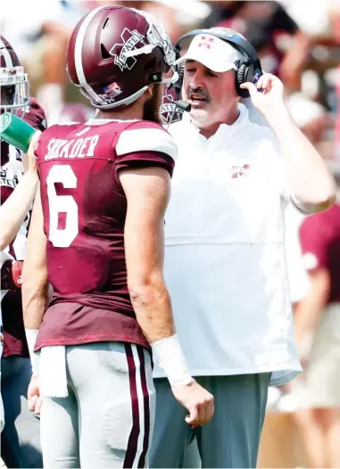  ??  ?? Mississipp­i State head coach Joe Moorhead, right, speaks with quarterbac­k Garrett Shrader during a timeout in the second half of a game earlier this season. (Photo by Rogelio V. Solis, AP file)