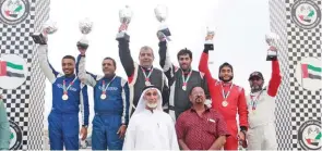  ?? – Supplied photo ?? ON THE PODIUM: Oman’s Hamid Al Qasimi, second left, his co-driver Mohammed Al Mazroui, left, Khalid Soomar, right, and his co-pilot Issa Al Wardi celebrate on the podium.