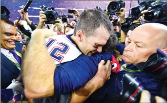  ?? ANTHONY BEHAR/TRIBUNE NEWS SERVICE ?? New England Patriots quarterbac­k Tom Brady (12) and New England Patriots head coach Bill Belichick celebrate during the post-game ceremony for Super Bowl LI after the New England Patriots defeated the Atlanta Falcons 34-28 in overtime on Sunday in...