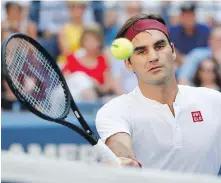  ?? AP ?? Roger Federer returns a shot to Nick Kyrgios during the third round of the U.S. Open tennis tournament on Saturday.