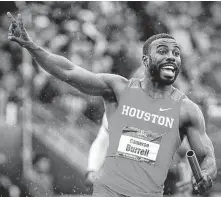  ?? Andy Nelson / Associated Press ?? Cameron Burrell raises two fingers to indicate Houston's back-to-back men's 400-meter relay wins.