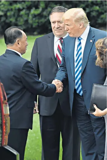  ??  ?? Donald Trump shakes hands with Kim Yong-chol outside the White House, watched by Secretary of State Mike Pompeo