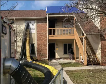  ?? MACOMB DAILY PHOTO ?? A restoratio­n company works to repair fire damage at the second-level residence of the late Lisa Marrone where her stabbed body was found by Roseville firefighte­rs responding to a blaze. It appears the unit underneath Marrone’s residence also was damaged.