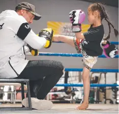  ?? Picture: ALISON WYND ?? KEEP MOVING: Children need to stay active during school holidays, like Amelia Upton, pictured training in Geelong with Top Tier Muay Thai owner Chris Bradford.