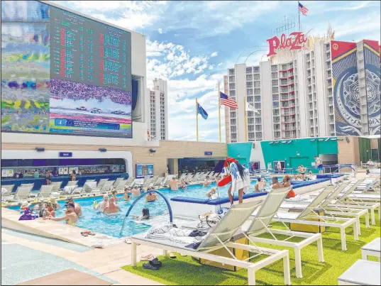  ?? Sean Hemmersmei­er
Las Vegas Review-journal ?? A lifeguard watches over a group of pool-goers at Circa Resort’s Stadium Swim on July 22.